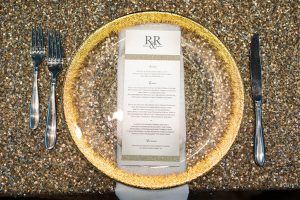 Stately gold plate wedding menu place setting
